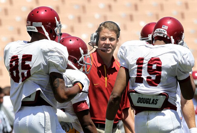 LOS ANGELES, CA - MAY 01:  Head coach Lane Kiffin gives instructions in the offensive huddle during the  USC Trojans spring game on  May 1, 2010 at the Los Angeles Memorial Coliseum in Los Angeles, California.  (Photo by Stephen Dunn/Getty Images)