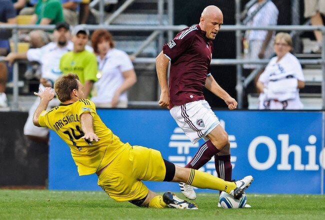 COLUMBUS, OH - AUGUST 21:  Chad Marshall #14 of the Columbus Crew attempts a tackle on Conor Casey #9 of the Colorado Rapids on August 21, 2010 at Crew Stadium in Columbus, Ohio.  (Photo by Jamie Sabau/Getty Images)