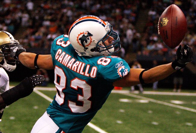 NEW ORLEANS - SEPTEMBER 03:  Greg Camarillo #83 of the Miami Dolphins tries to catch a pass over Malcolm Jenkins #27 of the New Orleans Saints at the Louisiana Superdome on September 3, 2009 in New Orleans, Louisiana.  (Photo by Chris Graythen/Getty Images)