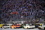 BRISTOL, TN - AUGUST 18:  Elliott Sadler, driver of the #2 Grand Touring Vodka Chevrolet, and James Buescher, driver of the #31 Wolf Pack Rentals/Volunteer Chevrolet, lead the field to start the NASCAR Camping World Truck Series O'Reilly 200 at Bristol Motor Speedway on August 18, 2010 in Bristol, Tennessee.  (Photo by Rusty Jarrett/Getty Images for NASCAR)