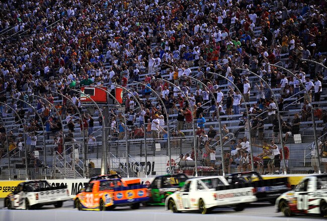 BRISTOL, TN - AUGUST 18:  Elliott Sadler, driver of the #2 Grand Touring Vodka Chevrolet, and James Buescher, driver of the #31 Wolf Pack Rentals/Volunteer Chevrolet, lead the field to start the NASCAR Camping World Truck Series O'Reilly 200 at Bristol Motor Speedway on August 18, 2010 in Bristol, Tennessee.  (Photo by Rusty Jarrett/Getty Images for NASCAR)