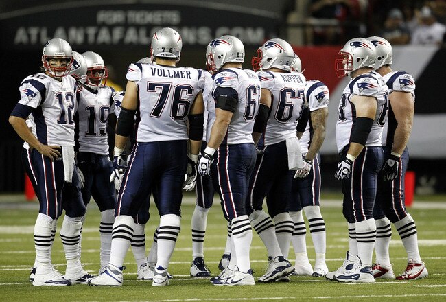 ATLANTA - AUGUST 19:  The New England Patriots offense, led by quarterback Tom Brady #12 (L), huddles before a play during the preseason game against the Atlanta Falcons at the Georgia Dome on August 19, 2010 in Atlanta, Georgia.  The Patriots beat the Falcons 28-10.  (Photo by Mike Zarrilli/Getty Images)