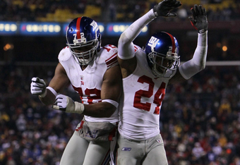 LANDOVER, MD - DECEMBER 21:  (R-L) Terrell Thomas #24 of the New York Giants and Osi Umenyiora #72 celebrate after Thomas scored on an interception return for a touchdown in the third quarter against  the Washington Redskins at FedEx Field on December 21, 2009 in Landover, Maryland. (Photo by Al Bello/Getty Images)