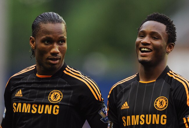 WIGAN, ENGLAND - AUGUST 21:  Didier Drogba of Chelsea jokes with John Obi Mikel prior to the Barclays Premier League match between Wigan Athletic and Chelsea at DW Stadium on August 21, 2010 in Wigan, England.  (Photo by Getty Images for Chelsea FC)
