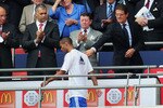 LONDON, ENGLAND - AUGUST 08:  Ashley Cole of Chelsea walks past England manager Fabio Capello as he collects his medal after defeat in the FA Community Shield match between Chelsea and Manchester United at Wembley Stadium on August 8, 2010 in London, England.  (Photo by Shaun Botterill/Getty Images)
