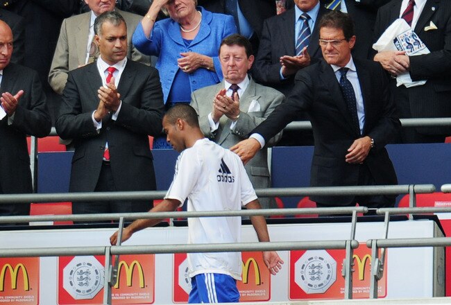 LONDON, ENGLAND - AUGUST 08:  Ashley Cole of Chelsea walks past England manager Fabio Capello as he collects his medal after defeat in the FA Community Shield match between Chelsea and Manchester United at Wembley Stadium on August 8, 2010 in London, England.  (Photo by Shaun Botterill/Getty Images)