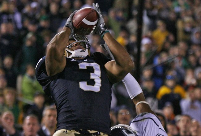 SOUTH BEND, IN - NOVEMBER 21: Michael Floyd #3 of the Notre Dame Fighting Irish catches a pass in overtime as Robert McClain #42 of the Univeristy of Connecticut Huskies defends at Notre Dame Stadium on November 21, 2009 in South Bend, Indiana. Connecticut defeated Notre Dame 33-30 in overtime. (Photo by Jonathan Daniel/Getty Images)