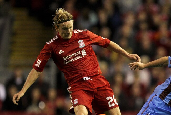 LIVERPOOL, ENGLAND - AUGUST 19:  Christian Poulsen of Liverpool battles for the ball with Serkan Balci of Trabzonspor during the UEFA Europa League play-off first leg match beteween Liverpool and Trabzonspor at Anfield on August 19, 2010 in Liverpool, England.  (Photo by Alex Livesey/Getty Images)