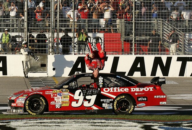 HAMPTON, GA - OCTOBER 26:  Carl Edwards, driver of the #99 Office Depot Ford, celebrates by performing a backflip after winning the NASCAR Sprint Cup Series Pep Boys Auto 500 at Atlanta Motor Speedway on October 26, 2008 in Hampton, Georgia.  (Photo by Jason Smith/Getty Images for NASCAR)