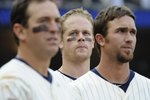 MINNEAPOLIS, MN - APRIL 12: Left to right, Nick Punto #8, Justin Morneau #33 and J.J. Hardy #27 of the Minnesota Twins during the singing of God Bless America in the middle of the seventh inning in a game against the Boston Red Sox during the Twins home opener at Target Field on April 12, 2010 in Minneapolis, Minnesota. (Photo by Hannah Foslien /Getty Images)