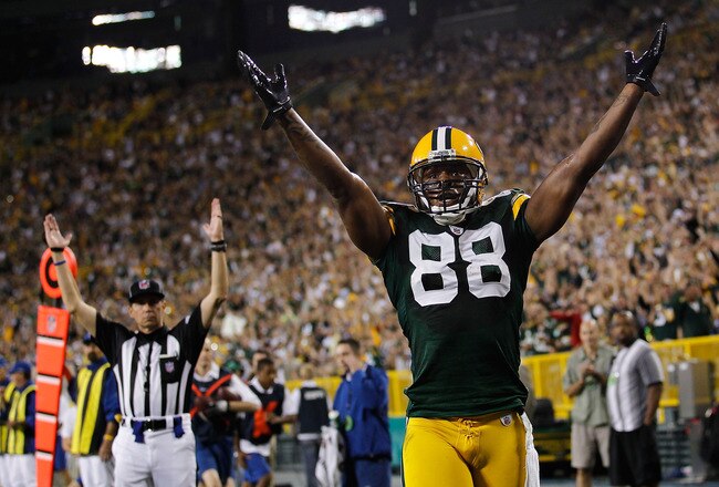 GREEN BAY, WI - AUGUST 26: Jermichael Finley #88 of the Green Bay Packers signals, along with a referee, a touchdown against the Indianapolis Colts during a preseason game at Lambeau Field on August 26, 2010 in Green Bay, Wisconsin. (Photo by Jonathan Daniel/Getty Images)