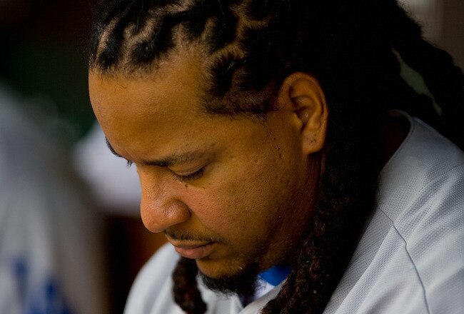 ST. LOUIS - JULY 18: Manny Ramirez #99 of the Los Angeles Dodgers sits in the dugout against the St. Louis Cardinals at Busch Stadium on July 18, 2010 in St. Louis, Missouri.  (Photo by Dilip Vishwanat/Getty Images)