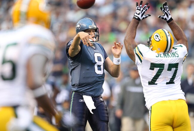 SEATTLE - AUGUST 21:  Quarterback Matt Hasselbeck #8 of the Seattle Seahawks throws a touchdown pass to Deion Branch #83 during the preseason game against Cullen Jenkins #77 of the Green Bay Packers at Qwest Field on August 21, 2010 in Seattle, Washington. (Photo by Otto Greule Jr/Getty Images)