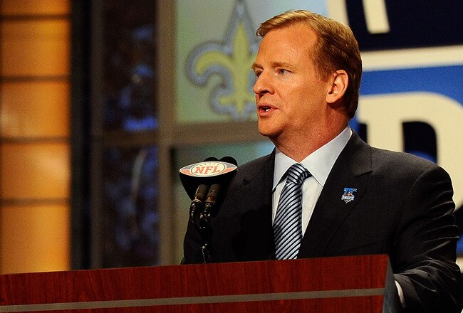 NEW YORK - APRIL 22:  NFL Commissioner Roger Goodell (R) introduces Drew Brees of the New Orleans Saints during the first round of the 2010 NFL Draft at Radio City Music Hall on April 22, 2010 in New York City. Brees then announced that the Saints had selected Patrick Robinson from Florida State with the last pick of the first round (number 32 overall). (Photo by Jeff Zelevansky/Getty Images)