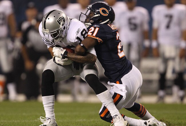 CHICAGO - AUGUST 21: Cory Graham #21 of the Chicago Bears tackles Louis Murphy #18 of the Oakland Raiders during a preseason game at Soldier Field on August 21, 2010 in Chicago, Illinois. The Raiders defeated the Bears 32-17. (Photo by Jonathan Daniel/Getty Images)