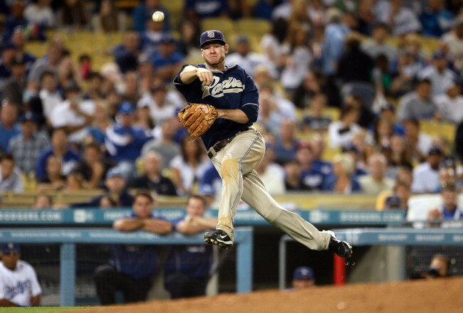 LOS ANGELES, CA - AUGUST 04:  Third baseman Chase Headley #7 of San Diego Padres throws to first but isn't able to get Jamey Carroll of the Los Angeles Dodgers out in the eighth inning at Dodger Stadium on August 4, 2010 in Los Angeles, California. The Dodgers defeated the Padres 9-0.  (Photo by Jeff Gross/Getty Images)