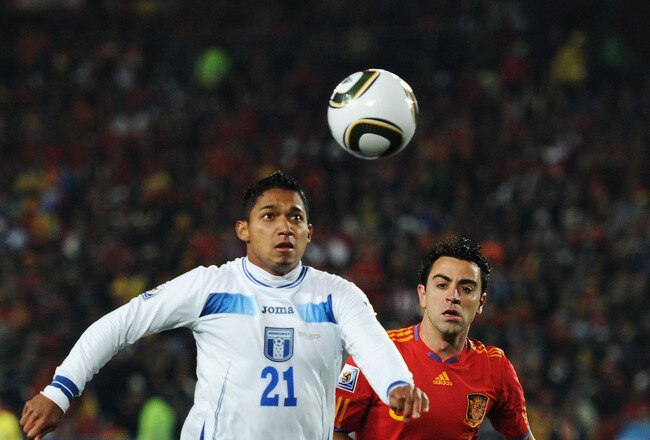 JOHANNESBURG, SOUTH AFRICA - JUNE 21: Xavi Hernandez of Spain challenges Emilio Izaguirre of Honduras during the 2010 FIFA World Cup South Africa Group H match between Spain and Honduras at Ellis Park Stadium on June 21, 2010 in Johannesburg, South Africa.  (Photo by Jasper Juinen/Getty Images)