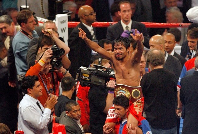 ARLINGTON, TX - MARCH 13:  Manny Pacquiao of the Philippines celebrates in the ring after defeating Joshua Clottey of Ghana during the WBO welterweight title fight at Cowboys Stadium on March 13, 2010 in Arlington, Texas. Pacquiao defeated Clottey by unanimous decision.  (Photo by Tom Pennington/Getty Images)