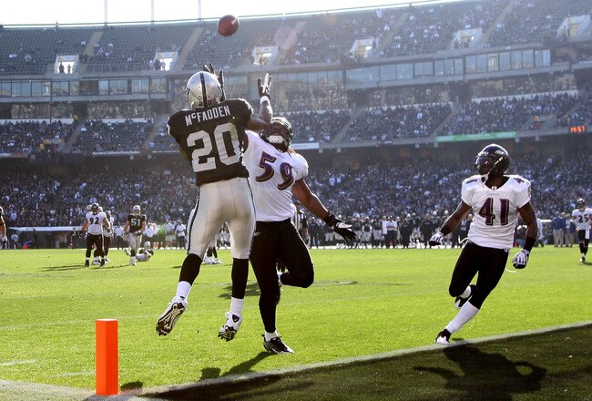OAKLAND, CA - JANUARY 03:  Darren McFadden #20 of the Oakland Raiders can't hang on to a pass as Dannell Ellerbe #59 of the Baltimore Ravens defends during an NFL game at Oakland-Alameda County Coliseum on January 3, 2010 in Oakland, California.  (Photo by Jed Jacobsohn/Getty Images)