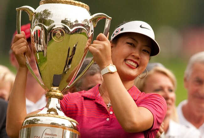 WINNIPEG, CANADA - AUGUST 29: Michelle Wie of the U.S. holds up the winner's trophy after her victory at the CN Canadian Women's Open at St. Charles Country Club on August 29, 2010 in Winnipeg, Manitoba, Canada. (Photo by Darren Carroll/Getty Images)