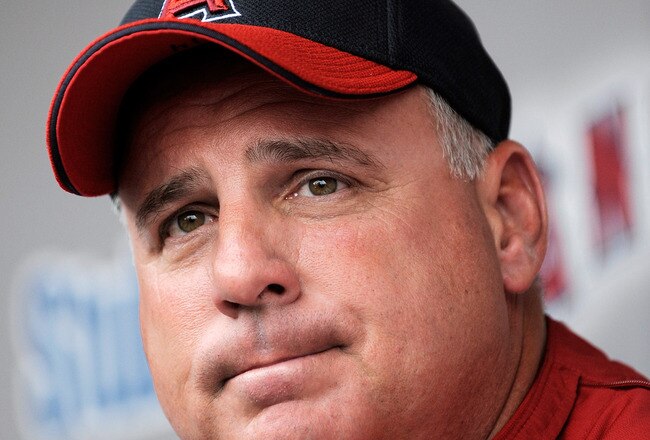 ANAHEIM, CA - APRIL 10:  Mike Scioscia #14 manager of the Los Angeles Angels reflects on pitcher Nick Adenhart's death as he answers questions in the dugout at Angel Stadium April 10, 2009 in Anaheim, California. Adenhart and two others were killed in car crash on April 9.  (Photo by Kevork Djansezian/Getty Images)