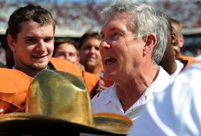 DALLAS - OCTOBER 17:  Head coach Mack Brown of the Texas Longhorns holds the Red River Rivalry trophy after a win against the Okalhoma Sooners at Cotton Bowl on October 17, 2009 in Dallas, Texas.  (Photo by Ronald Martinez/Getty Images)