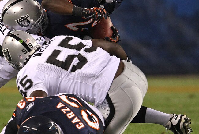 CHICAGO - AUGUST 21: Chester Taylor #29 of the Chicago Bears tries to break away from Kamerion Wimbley #96 and Rolando McClain #55 of the Oakland Raiders and past teammate Roberto Garza #63 during a preseason game at Soldier Field on August 21, 2010 in Chicago, Illinois. The Raiders defeated the Bears 32-17. (Photo by Jonathan Daniel/Getty Images)