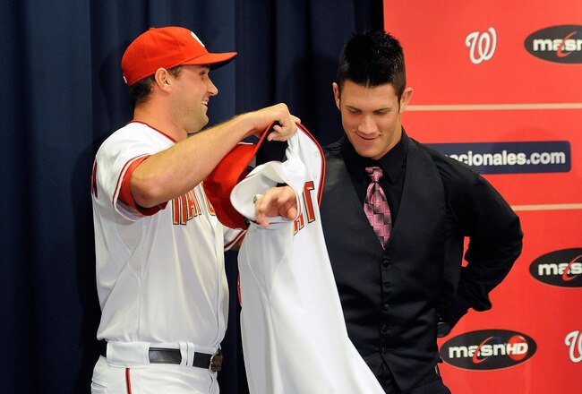 WASHINGTON - AUGUST 26:  Ryan Zimmerman #11 of the Washington Nationals presents Bryce Harper #34 with his jersey during a press conference at Nationals Park on August 26, 2010 in Washington, DC.  (Photo by Greg Fiume/Getty Images)