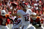 DALLAS - OCTOBER 17:  Quarterback Landry Jones #12 of the Oklahoma Sooners drops back to pass against the Texas Longhorns at Cotton Bowl on October 17, 2009 in Dallas, Texas.  (Photo by Ronald Martinez/Getty Images)