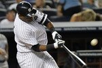 NEW YORK - JULY 22: Marcus Thames #38 of the New York Yankees hits a RBI sacrifice fly to score Jorge Posada #20 against the Kansas City Royals at Yankee Stadium on July 22, 2010 in the Bronx borough of New York City.  (Photo by Nick Laham/Getty Images)