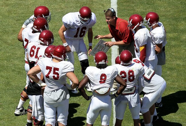 LOS ANGELES, CA - MAY 01:  Head coach Lane Kiffin gives instructions in the offensive huddle during the  USC Trojans spring game on  May 1, 2010 at the Los Angeles Memorial Coliseum in Los Angeles, California.  (Photo by Stephen Dunn/Getty Images)