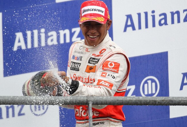 SPA FRANCORCHAMPS, BELGIUM - AUGUST 29:  Lewis Hamilton of Great Britain and McLaren Mercedes celebrates on the podium after winning the Belgian Formula One Grand Prix at the Circuit of Spa Francorchamps on August 29, 2010 in Spa Francorchamps, Belgium.  (Photo by Paul Gilham/Getty Images)