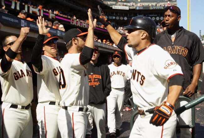 SAN FRANCISCO - AUGUST 29:  Andres Torres #56 of the San Francisco Giants is congratulated by teammates after he scored to give the Giants a 9-7 lead in the eighth inning of their game against the Arizona Diamondbacks at AT&T Park on August 29, 2010 in San Francisco, California.  (Photo by Ezra Shaw/Getty Images)