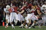 PASADENA, CA - JANUARY 07:  Quarterback Greg McElroy #12 of the Alabama Crimson Tide hands the ball off to running back Trent Richardson #3 for a 49-yard touchdown against the Texas Longhorns in the second quarter of the Citi BCS National Championship game at the Rose Bowl on January 7, 2010 in Pasadena, California.  (Photo by Harry How/Getty Images)