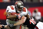 ATLANTA - NOVEMBER 29:  Kroy Biermann #71 of the Atlanta Falcons tackles Derrick Ward #28 of the Tampa Bay Buccaneers at Georgia Dome on November 29, 2009 in Atlanta, Georgia.  (Photo by Kevin C. Cox/Getty Images)