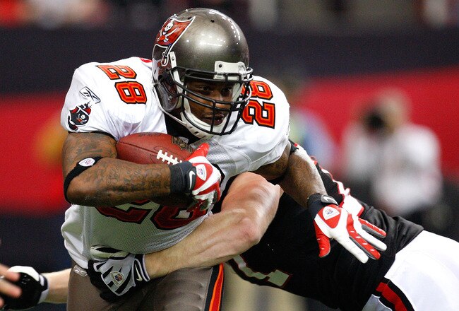ATLANTA - NOVEMBER 29:  Kroy Biermann #71 of the Atlanta Falcons tackles Derrick Ward #28 of the Tampa Bay Buccaneers at Georgia Dome on November 29, 2009 in Atlanta, Georgia.  (Photo by Kevin C. Cox/Getty Images)