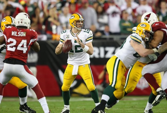 GLENDALE, AZ - JANUARY 10:  Quarterback Aaron Rodgers #12 of the Green Bay Packers drops back to pass during the 2010 NFC wild-card playoff game against the Arizona Cardinals at the Universtity of Phoenix Stadium on January 10, 2010 in Glendale, Arizona.  The Cardinals defeated the Packers  51-45 in overtime.  (Photo by Christian Petersen/Getty Images)