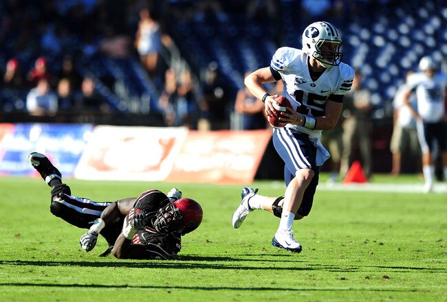 SAN DIEGO - OCTOBER 17:  Max Hall #15 of BYU Cougars runs the ball and avoids getting tackeled by Miles Burris #9 of San Diego State Aztecs at Qualcomm Stadium on October 17, 2009 in San Diego, California. BYU Cougars defeated the Aztecs 38-28  (Photo by Jacob de Golish/Getty Images)