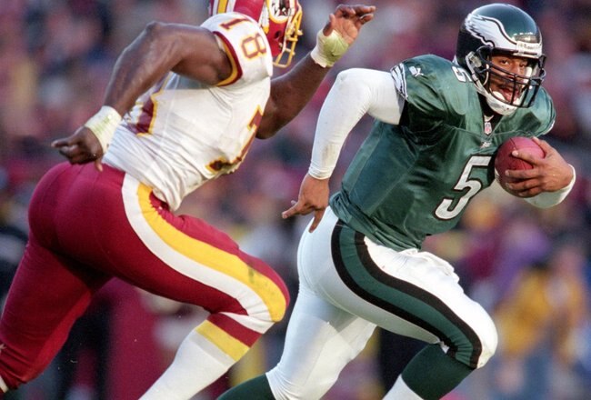 26 Nov 2000:  Donovan McNabb #5 of the Philadelphia Eaglesruns with the ball from Bruce SMith #78 of the Washington Redskins during the game at the FedEx Field in Landover, Maryland. The Eagles defeated the Redskins 23-20.Mandatory Credit: Jamie Squire  /Allsport