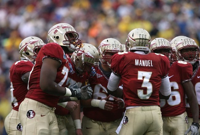 JACKSONVILLE, FL - JANUARY 01:  Quarterback E.J. Manuel #3 of the Florida State Seminoles calls out a play in the huddle against the West Virginia Mountaineers during the Konica Minolta Gator Bowl on January 1, 2010 at Jacksonville Municipal Stadium in Jacksonville, Florida. Florida State defeated West Virginia 33-21 in Bobby Bowden's last game as a head coach for the Seminoles.  (Photo by Doug Benc/Getty Images)