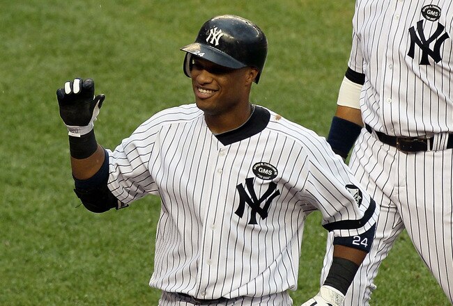 NEW YORK - AUGUST 22:  Robinson Cano #24 of the New York Yankees celebrates his fifth inning grand slam home run against the Seattle Mariners with teammate Nick Swisher #33 on August 22, 2010 at Yankee Stadium in the Bronx borough of New York City.  (Photo by Jim McIsaac/Getty Images)