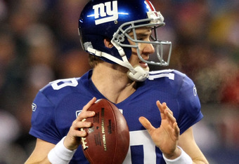 EAST RUTHERFORD, NJ - DECEMBER 13:  Eli Manning #10 of the New York Giants drops back to pass against the Philadelphia Eagles at Giants Stadium on December 13, 2009 in East Rutherford, New Jersey.  (Photo by Nick Laham/Getty Images)