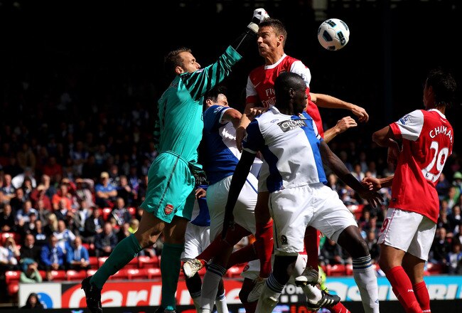 BLACKBURN, ENGLAND - AUGUST 28:  Manuel Almunia of Arsenal punches clear under pressure from Chris Samba of Blackburn Rovers during the Barclays Premier League match between Blackburn Rovers and Arsenal at Ewood Park on August 28, 2010 in Blackburn, England.  (Photo by Alex Livesey/Getty Images)