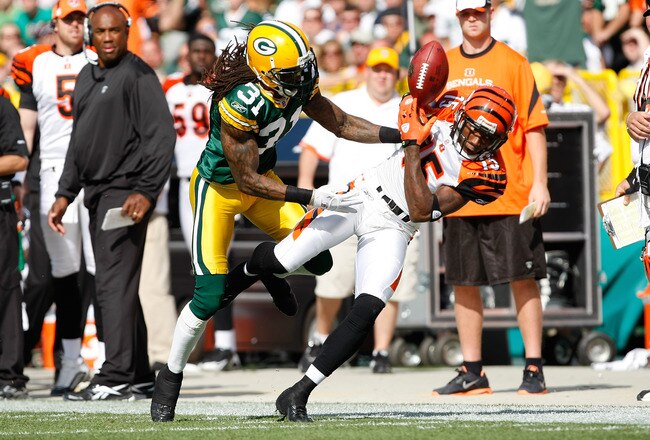 GREEN BAY, WI - SEPTEMBER 20: Wide receiver Chris Henry #15 of the Cincinnati Bengals reaches for the football as defensive back Al Harris #31 of the Green Bay Packers breaks up the play at Lambeau Field on September 20, 2009 in Green Bay, Wisconsin. The Bengals defeated the Packers 31-24. (Photo by Scott Boehm/Getty Images)