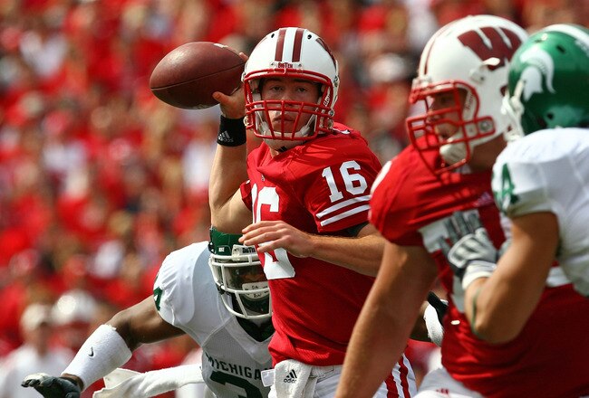 MADISON, WI - SEPTEMBER 26:  Scott Tolzien #16 of the Wisconsin Badgers passes under pressure from the Michigan State Spartans on September 26, 2009 at Camp Randall Stadium in Madison, Wisconsin.  (Photo by Jonathan Daniel/Getty Images)