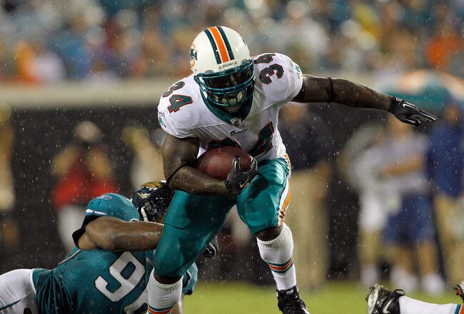 JACKSONVILLE, FL - AUGUST 21:  Terrance Knighton #96 of the Jacksonville Jaguars attempts to tackle Ricky Williams #34 of the Miami Dolphins during the preseason game at EverBank Field on August 21, 2010 in Jacksonville, Florida.  (Photo by Sam Greenwood/Getty Images)