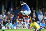 PORTSMOUTH, ENGLAND - AUGUST 28 :   John Utaka of Portsmouth leaps over the tackle of Lee Naylor of Cardiff City during the npower Championship match between Portsmouth and Cardiff City at Fratton Park on August 28, 2010 in Portsmouth, England.  (Photo by Jan Kruger/Getty Images)