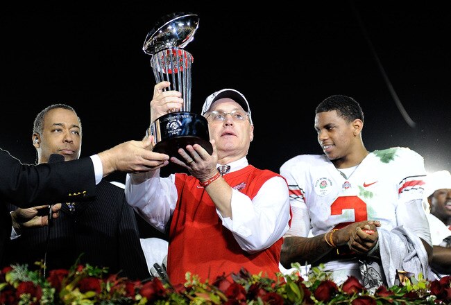 PASADENA, CA - JANUARY 01:  (C) Head coach Jim Tressel of the Ohio State Buckeyes celebrates with the Rose Bowl championship trophy as quarterback Terrelle Pryor #2 looks on after the buckeyes 26-17 win in the 96th Rose Bowl game over the Oregon Ducks on January 1, 2010 in Pasadena, California.  (Photo by Kevork Djansezian/Getty Images)