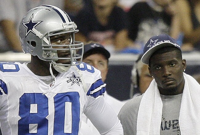 HOUSTON - AUGUST 28: Tight end Martellus Bennett #80 and injured wide receiver Dez Bryant of the Dallas Cowboys looks on from the sidelines during a pre-season football game against the Houston Texans at Reliant Stadium on August 28, 2010 in Houston, Texas. (Photo by Bob Levey/Getty Images)