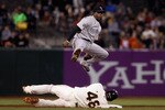 SAN FRANCISCO - AUGUST 31:  Eric Young Jr. #3 of the Colorado Rockies jumps over Pablo Sandoval #48 of the San Francisco Giants after he threw the ball to first base to turn a double play in the second inning at AT&T Park on August 31, 2010 in San Francisco, California.  (Photo by Ezra Shaw/Getty Images)
